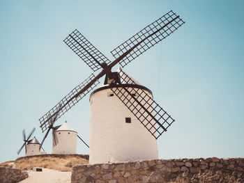 Low angle view of traditional windmill against clear sky