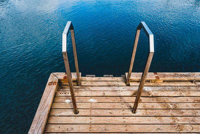 High angle view of ladder on pier by sea