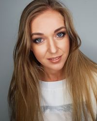 Portrait of beautiful young woman over white background