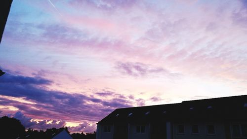 Low angle view of silhouette buildings against sky during sunset