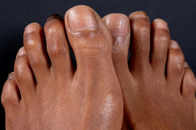 Close-up of human hand against black background