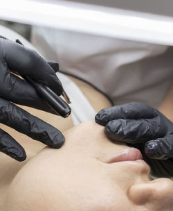 Low section of man sitting on bed