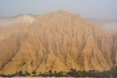 Scenic view of arid landscape against sky