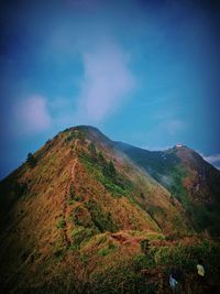 Scenic view of mountains against blue sky