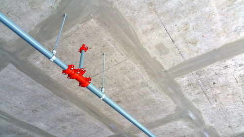 Low angle view of red pipe on wall