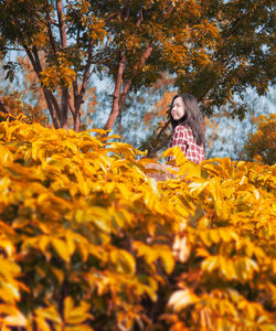 Young woman with yellow autumn leaves