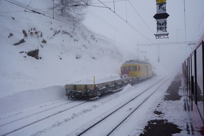 Train on snow covered railroad tracks during winter