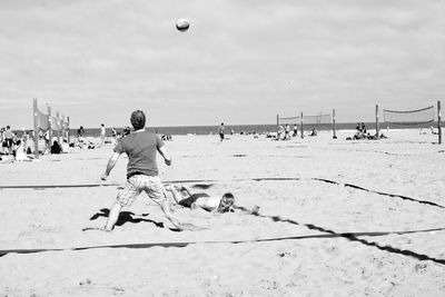 People on beach against sky