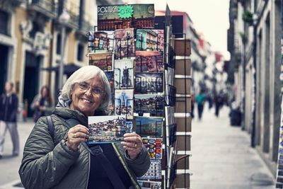 Woman shows vacation and tourism postcards
