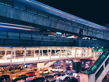 Train on bridge in city at night