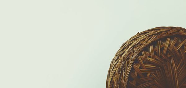 Close-up of wicker basket against clear sky