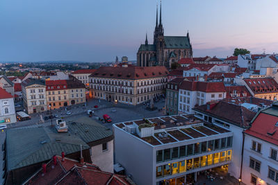 High angle view of old buildings in town against sky