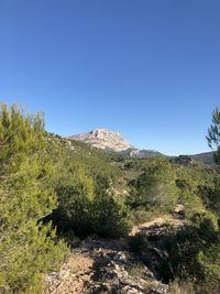 Scenic view of mountains against clear blue sky