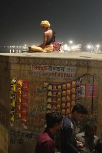 Group of people in front of sign at night