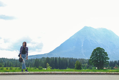 Asian women tourists and backpackers waiting car., tourist woman waiting for car on road outdoor.