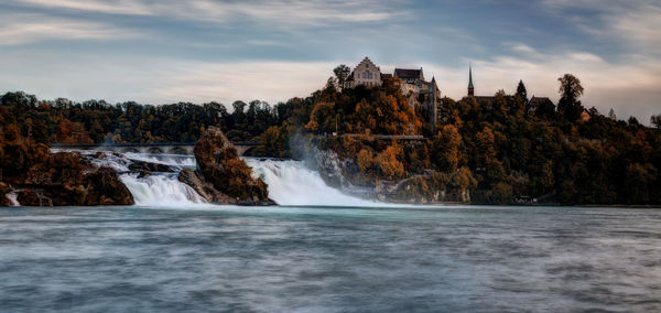 Long exposure photograph of the rhein falls with the laufen castle on the background.