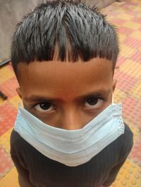 Close-up portrait of man covering face