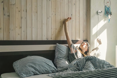 Young woman lying on bed at home