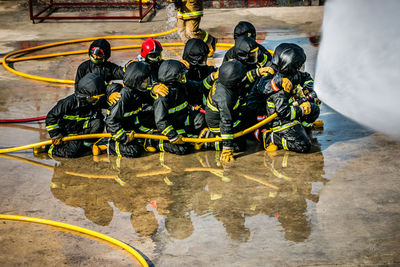 Firefighter spraying water on fire