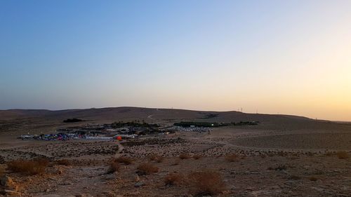 Scenic view of beach against clear sky during sunset