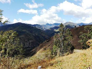 Scenic view of mountains against cloudy sky