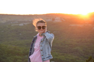 Portrait of wife wearing sunglasses standing on field