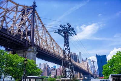 Low angle view of bridge against cloudy sky