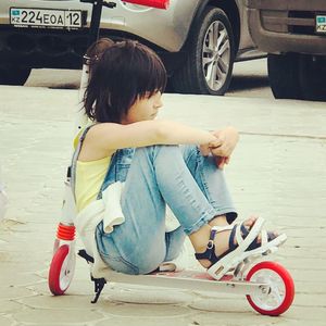 Boy riding motorcycle on road