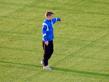 Boy playing with ball on field