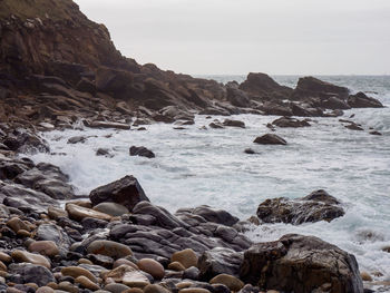 Scenic view of rocks in sea against sky