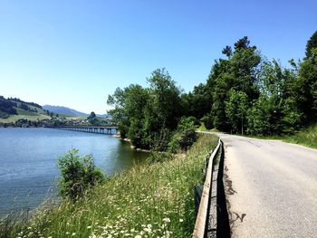 Scenic view of river against clear blue sky