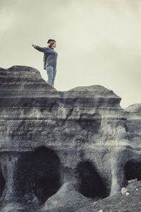 Rear view of man standing on rock