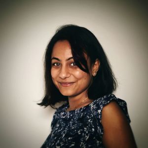 Portrait of smiling young woman against white background