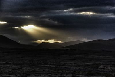 Scenic view of mountains against sky at sunset