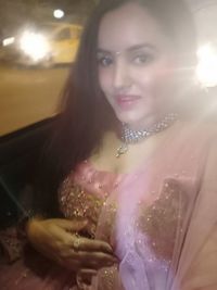 Portrait of a smiling young woman holding umbrella