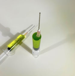 High angle view of glasses on table against white background