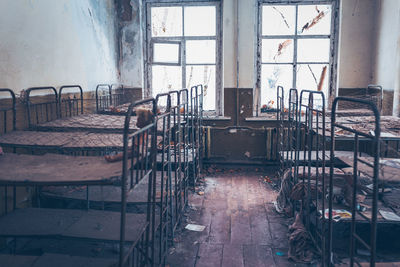 Empty chairs and tables in abandoned building