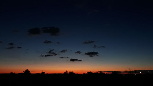 Silhouette trees against sky during sunset