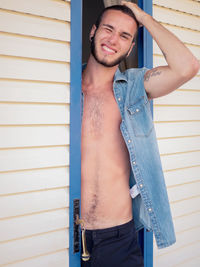 Close-up portrait of happy man standing at doorway