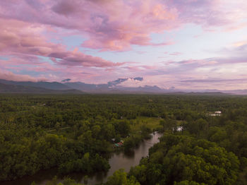 Scenic view of river against sky at sunset