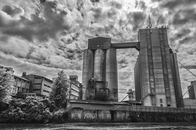 Low angle view of buildings against cloudy sky