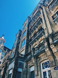 Low angle view of buildings against blue sky