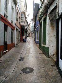 Cobblestone street amidst buildings