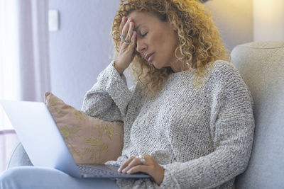 Young woman using laptop at home