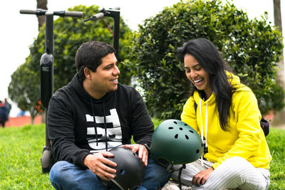 Young couple sitting outdoors