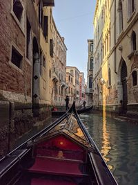 Canal amidst buildings against sky in city