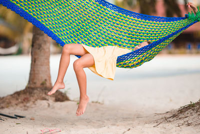 Girl relaxing on hammock at beach