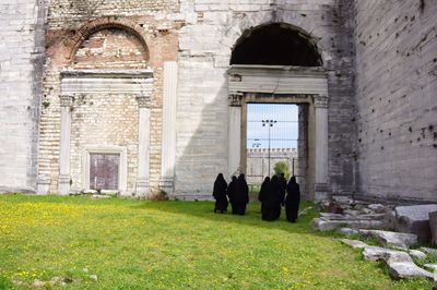 Rear view of people standing outside temple