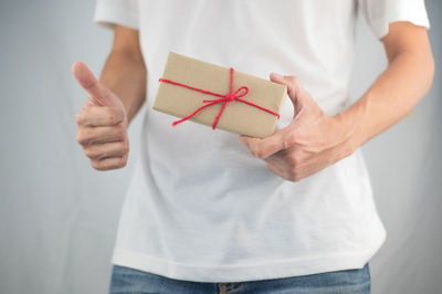 Midsection of woman holding umbrella standing in box