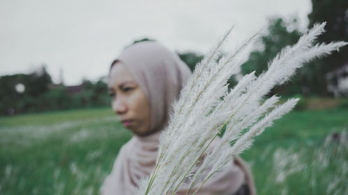 Close-up portrait of woman on field